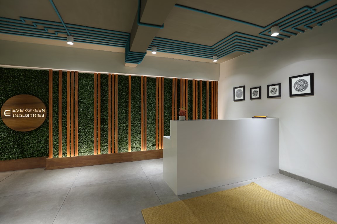 Reception with up lit greenwall as a back drop and chunk of blue conduits  creating a very creative line pattern. (Medium) - The Architects Diary